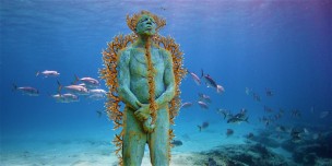 CANCUN, MEXICO - JANUARY 31: ***EXCLUSIVE*** Hombre en Llamas (Man on Fire) depicts a lone figure standing upright and defiant. The sculpture is installed 8m deep in the clear Caribbean waters surrounding the island of Isla Mujeres at a location named Manchiones. The cement figure has been drilled with over 75 holes and is currently being planted with live cuttings of fire coral (Millepora alcicorni). January 31, 2005. Deep under the seas of the Mexican Caribbean these statues look like relics of an ancient civilisation. Located in the National Marine Park, on the west coast of Isla Mujeres, Punta Cancun and Punta Nizuc, it will be the world's largest undetwater sculpture museum. Showing three life size sculptures are the first of 400 that will be laid on the seabed over the next 13 months. Founded by Jaime Gonzalez Cano of The National Marine Park, Roberto Diaz of The Cancun Nautical Association and renowned British underwater sculptor Jason deCaires Taylor, the underwater museum is designed to celebrate the Mayan history of the region and act as an artificial reef. (Photo by Jason de Caires / Barcroft Media / Getty Images)